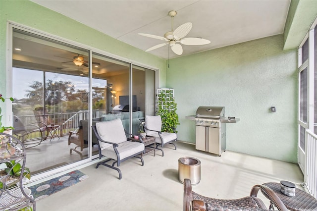 sunroom / solarium featuring ceiling fan