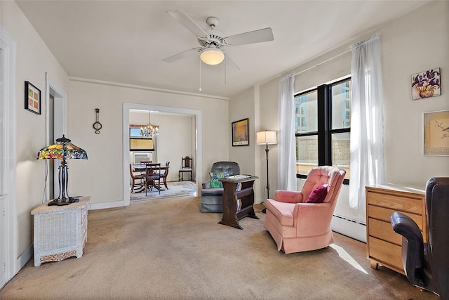 living area with baseboards, baseboard heating, carpet flooring, and ceiling fan with notable chandelier