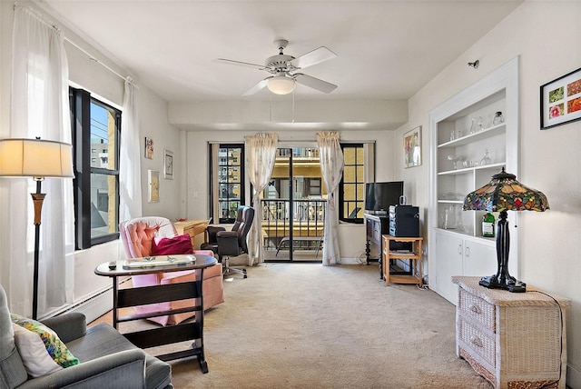 living area with carpet, built in shelves, and a ceiling fan