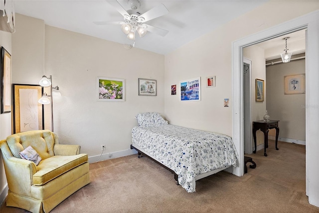 bedroom with carpet flooring, a ceiling fan, and baseboards