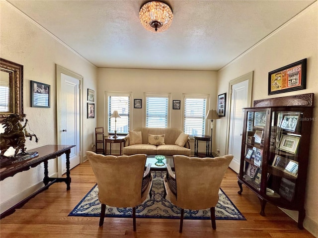 living room featuring plenty of natural light, a textured ceiling, and wood finished floors