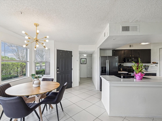 dining room with a chandelier, visible vents, a textured ceiling, and light tile patterned floors