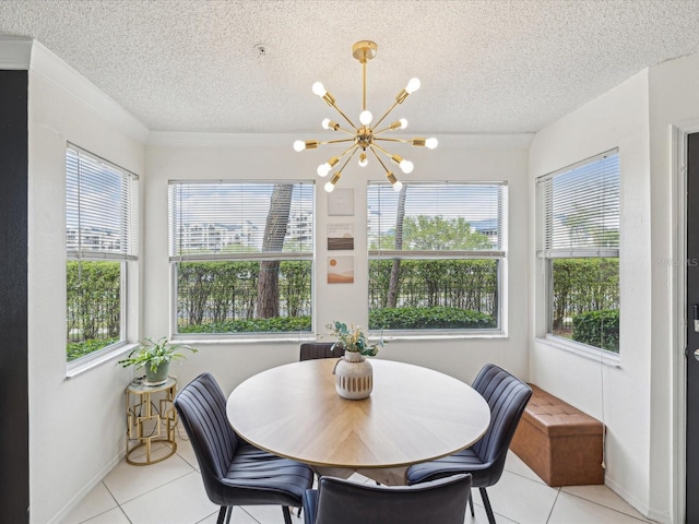 dining room featuring light tile patterned floors, baseboards, a textured ceiling, and an inviting chandelier