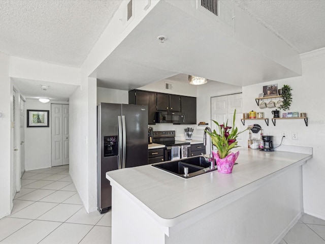 kitchen featuring a peninsula, light countertops, visible vents, and appliances with stainless steel finishes