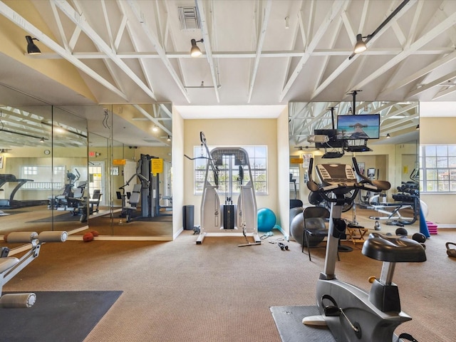 exercise room with visible vents and baseboards