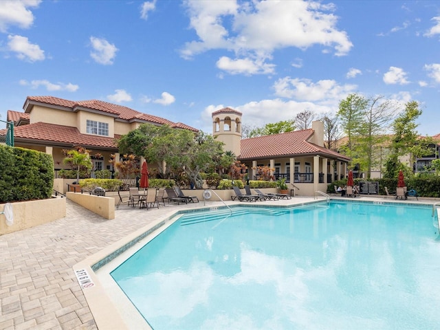 pool featuring a patio area and fence