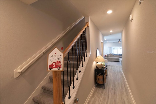 staircase with recessed lighting, ceiling fan, baseboards, and wood finished floors