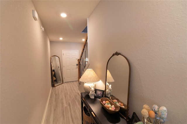 hall with light wood finished floors, recessed lighting, and baseboards