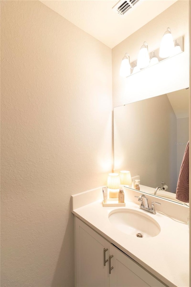 bathroom featuring visible vents and vanity