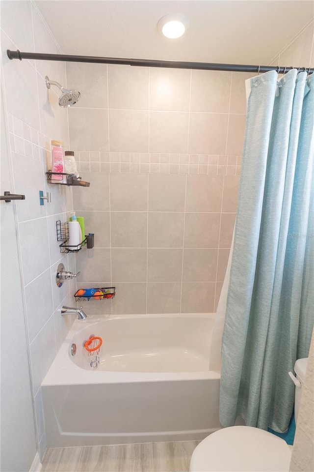 bathroom featuring toilet and shower / tub combo