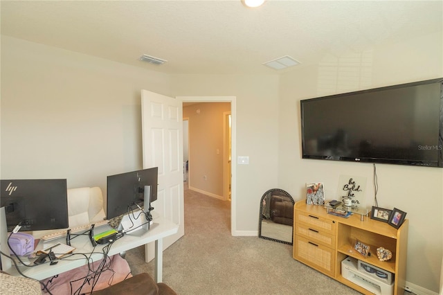 carpeted home office with baseboards and visible vents