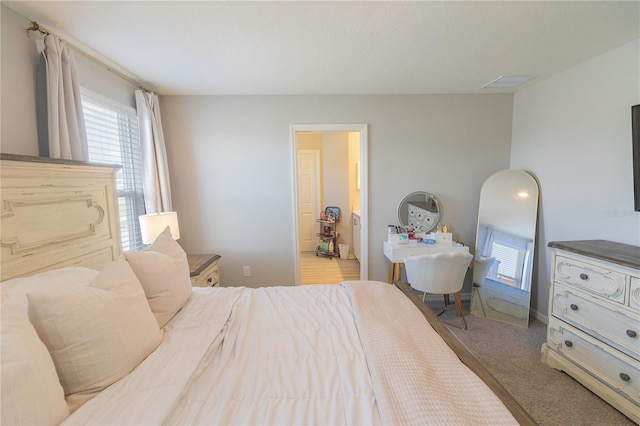 bedroom with visible vents and carpet floors