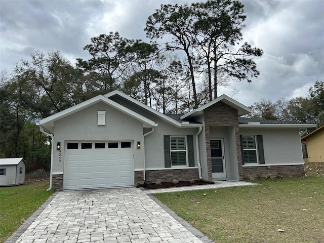 view of front of home with a front lawn, stucco siding, decorative driveway, stone siding, and an attached garage