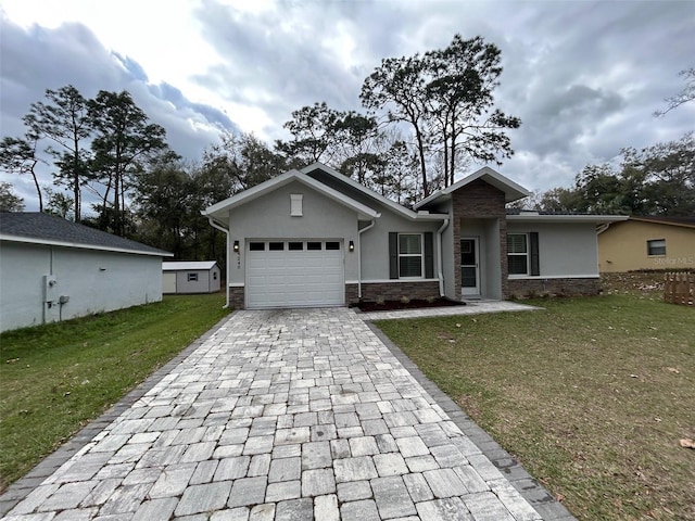 view of front facade with a front yard, stucco siding, a garage, stone siding, and decorative driveway