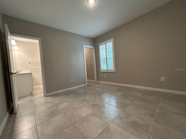 unfurnished bedroom featuring baseboards and light tile patterned flooring