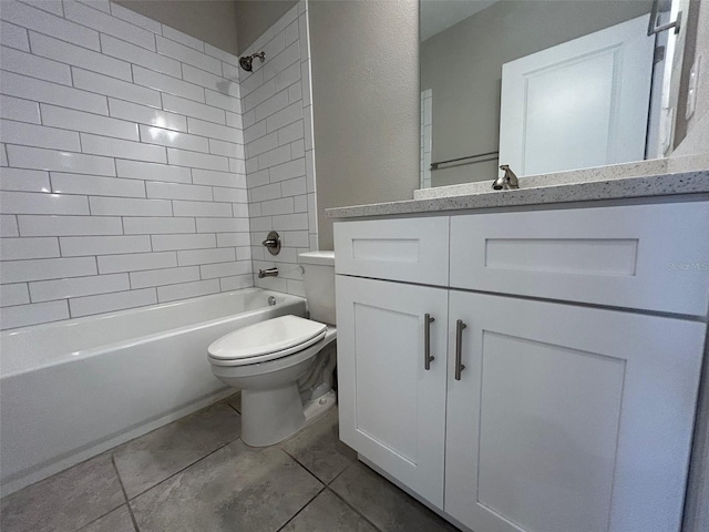 full bath featuring tile patterned floors, toilet, vanity, and washtub / shower combination