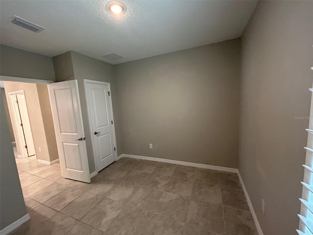 empty room with baseboards and visible vents