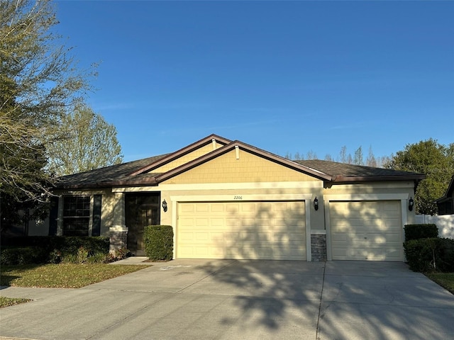 ranch-style house with stone siding, concrete driveway, and an attached garage