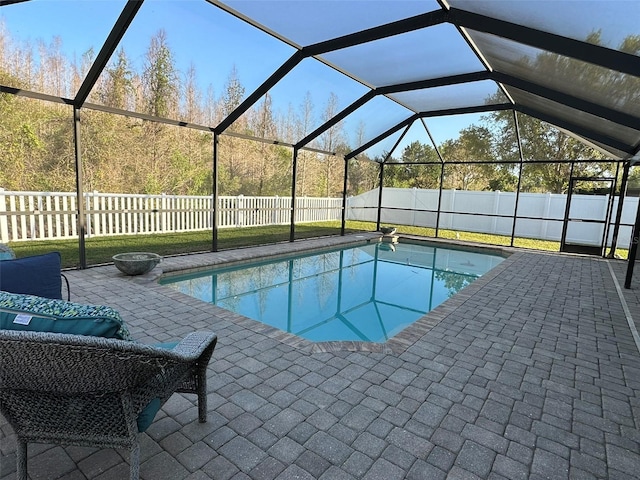 view of pool featuring a patio, a fenced backyard, a fenced in pool, and a lanai