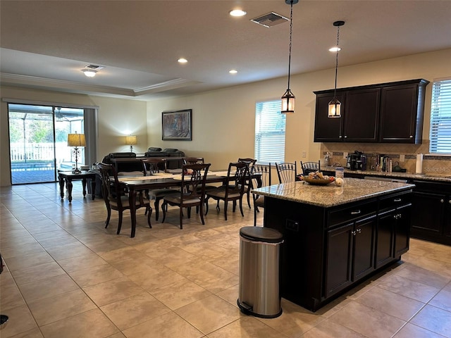 kitchen featuring open floor plan, backsplash, visible vents, and a wealth of natural light