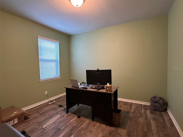 office area featuring dark wood finished floors, a textured ceiling, and baseboards