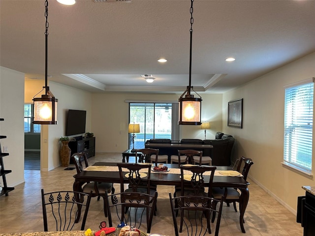 dining space with visible vents, baseboards, ornamental molding, recessed lighting, and a raised ceiling