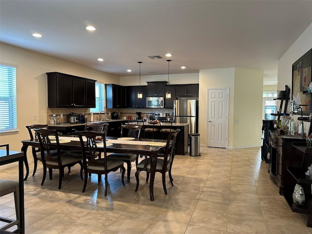 dining area featuring recessed lighting, visible vents, a healthy amount of sunlight, and light tile patterned flooring