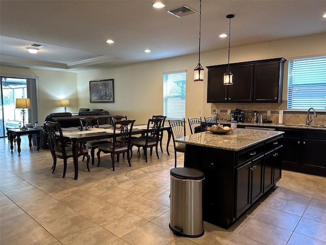 kitchen with open floor plan, a healthy amount of sunlight, visible vents, and a sink