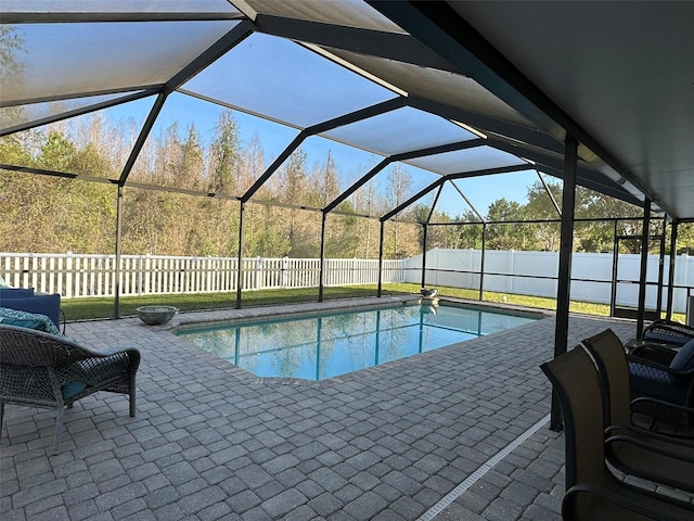 view of swimming pool featuring glass enclosure, a patio, a fenced backyard, and a fenced in pool