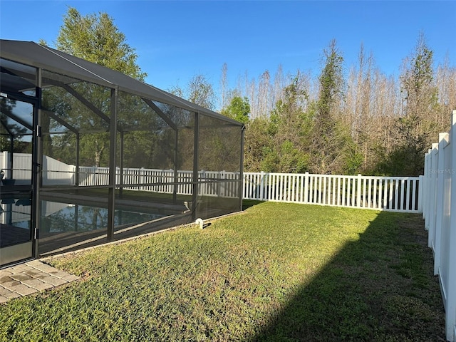 view of yard with a lanai, a fenced in pool, and a fenced backyard