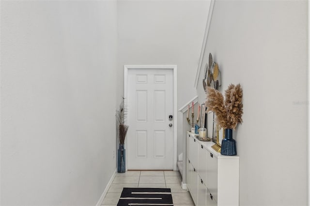 entryway featuring light tile patterned floors and baseboards