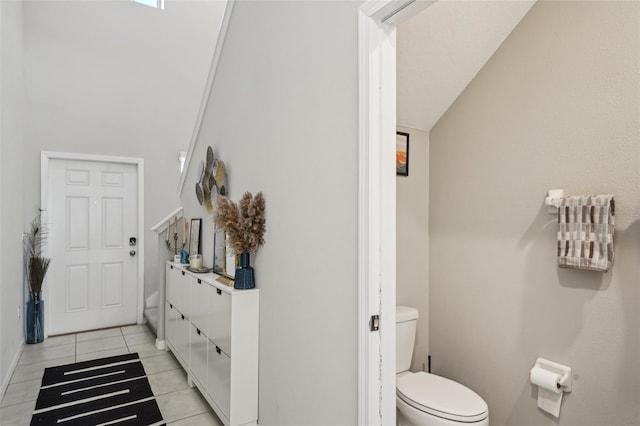 bathroom featuring tile patterned flooring, toilet, and vanity