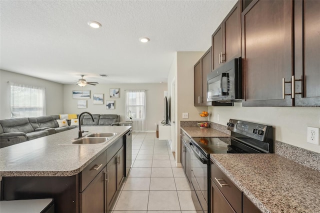 kitchen featuring a sink, a wealth of natural light, black appliances, and open floor plan