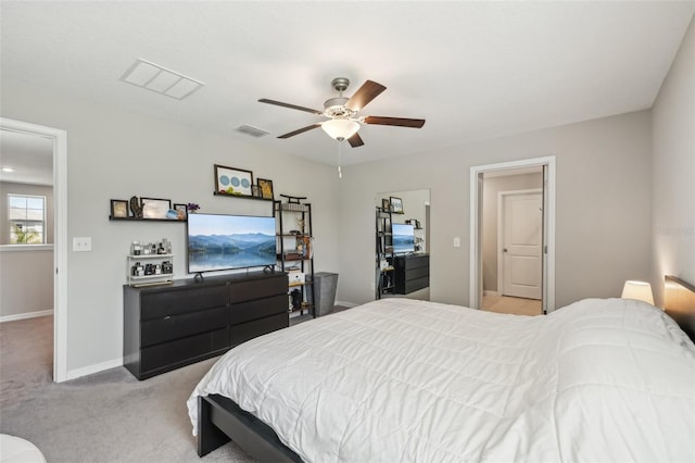 bedroom with visible vents, baseboards, light colored carpet, and a ceiling fan