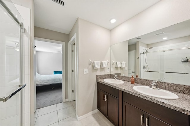 bathroom with a sink, visible vents, a stall shower, and tile patterned flooring