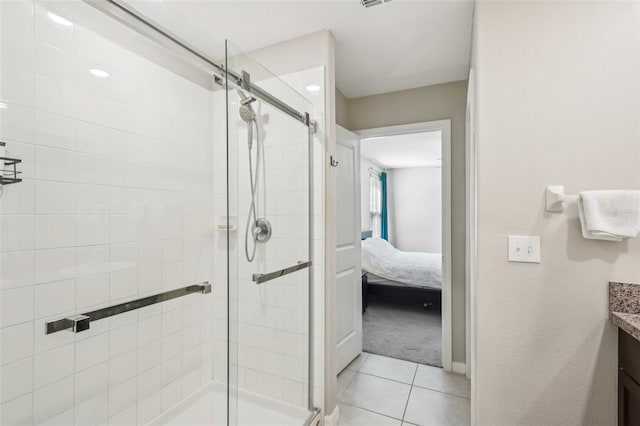 bathroom with vanity, a shower stall, ensuite bathroom, and tile patterned floors