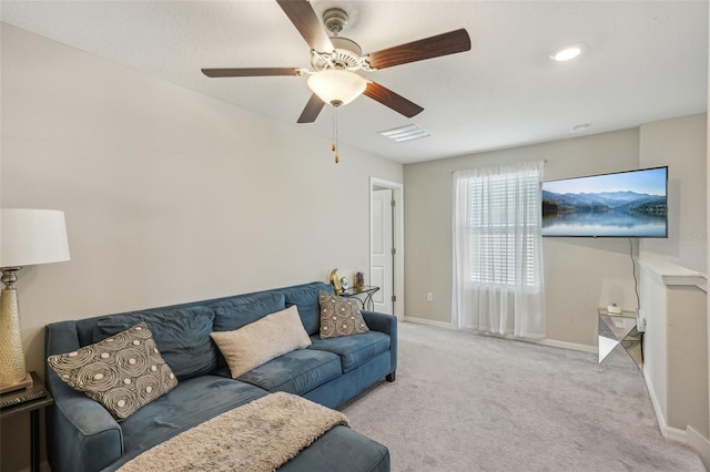 living area featuring carpet flooring, visible vents, baseboards, and ceiling fan