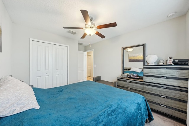 bedroom with visible vents, a closet, and a ceiling fan