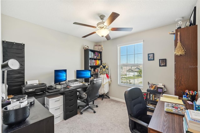 office with baseboards, light colored carpet, and ceiling fan