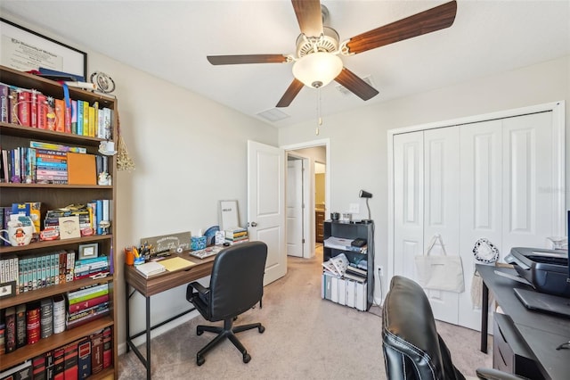 office area featuring light carpet and a ceiling fan