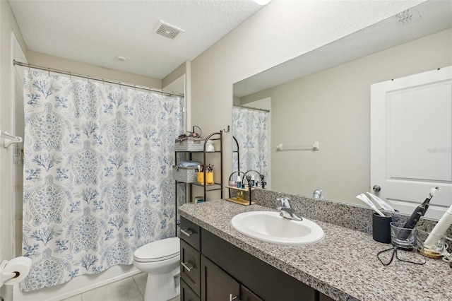 bathroom featuring tile patterned floors, visible vents, toilet, shower / tub combo with curtain, and vanity