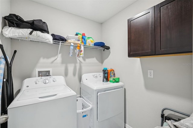 clothes washing area with cabinet space and washing machine and clothes dryer