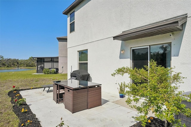 view of patio / terrace with area for grilling, outdoor dining area, and a water view