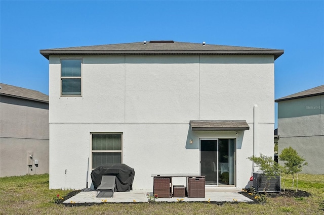 back of property featuring central AC unit, stucco siding, and a patio