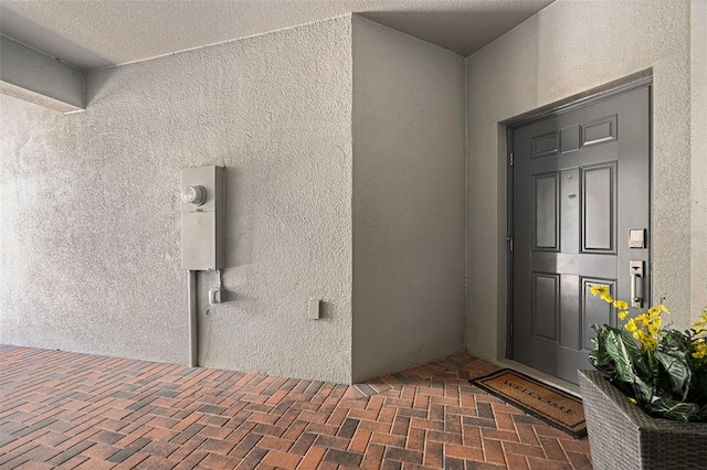 entrance to property with stucco siding