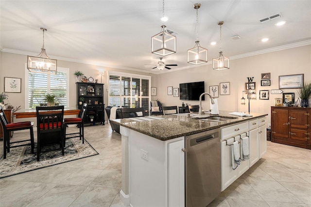 kitchen with visible vents, dark stone counters, a kitchen island with sink, a sink, and dishwasher