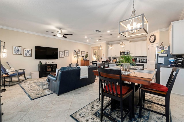 dining room with visible vents, ceiling fan with notable chandelier, recessed lighting, crown molding, and light tile patterned floors