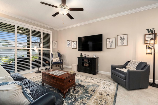 living room with a ceiling fan, baseboards, and ornamental molding