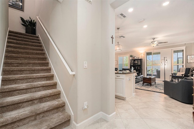 stairs with baseboards, visible vents, recessed lighting, ceiling fan, and crown molding