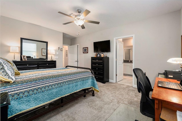 bedroom with connected bathroom, baseboards, light colored carpet, and ceiling fan